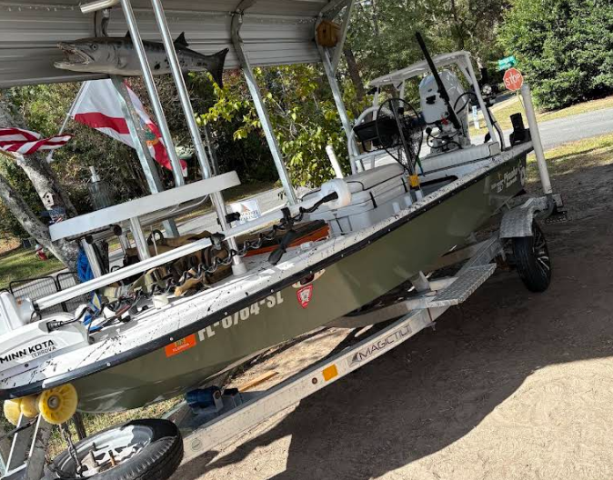 Close-up of an outboard motor clamped to the back of a boat.
